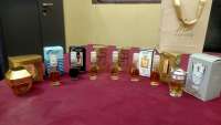 Assorted Smart Collection Perfume Miniatures, including small bottles and boxes, displayed on a reddish-purple surface.