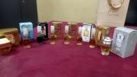 Assorted Smart Collection Perfume Miniatures in various gold, black, blue, and white boxes and small clear bottles.
