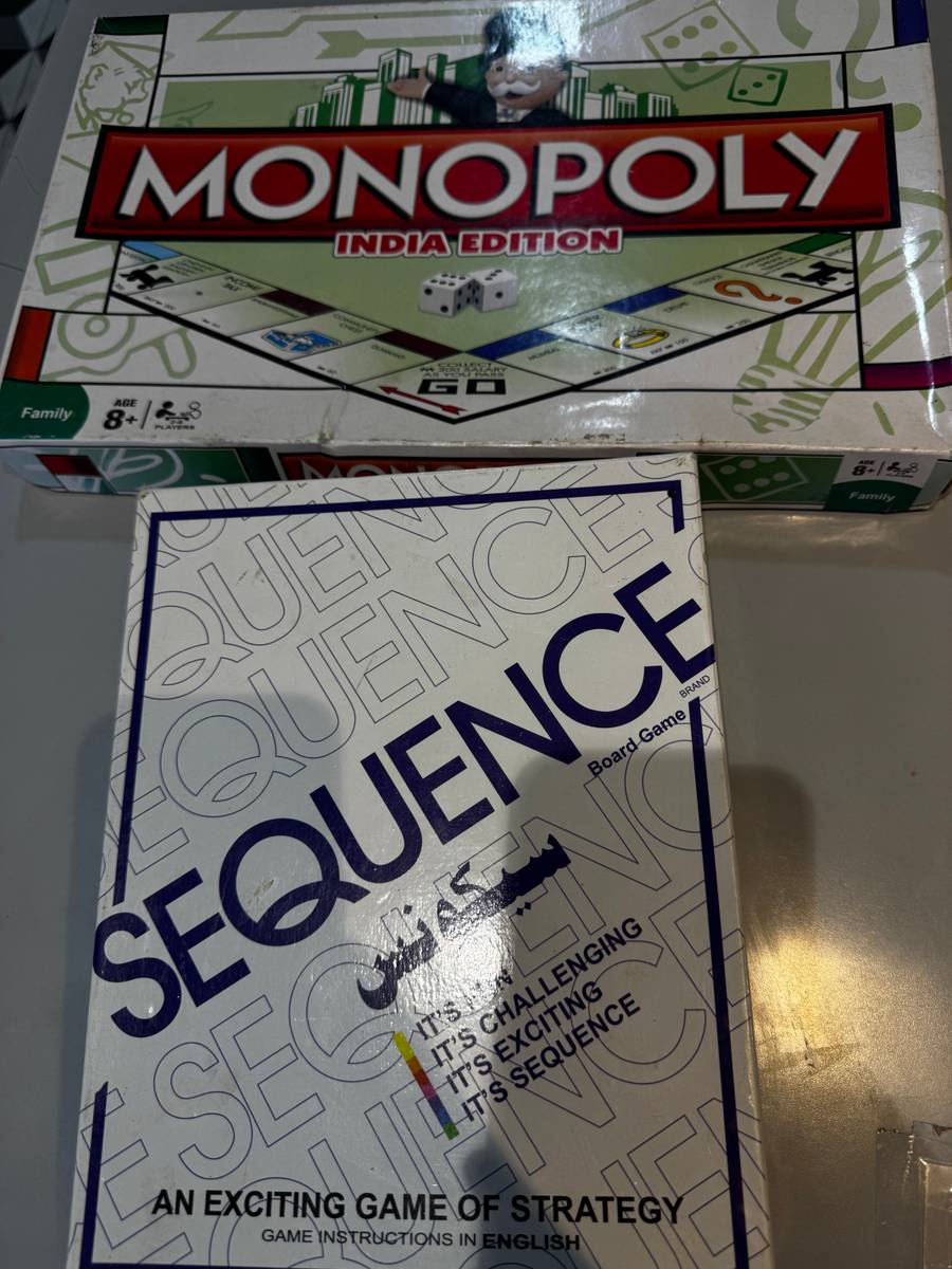 Two board game boxes: Monopoly India Edition, showing Mr. Monopoly and part of the board, and Sequence, a white box with blue