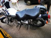 Silver Royal Enfield Bullet Classic 350 Cruiser with a black seat, parked on pavement.